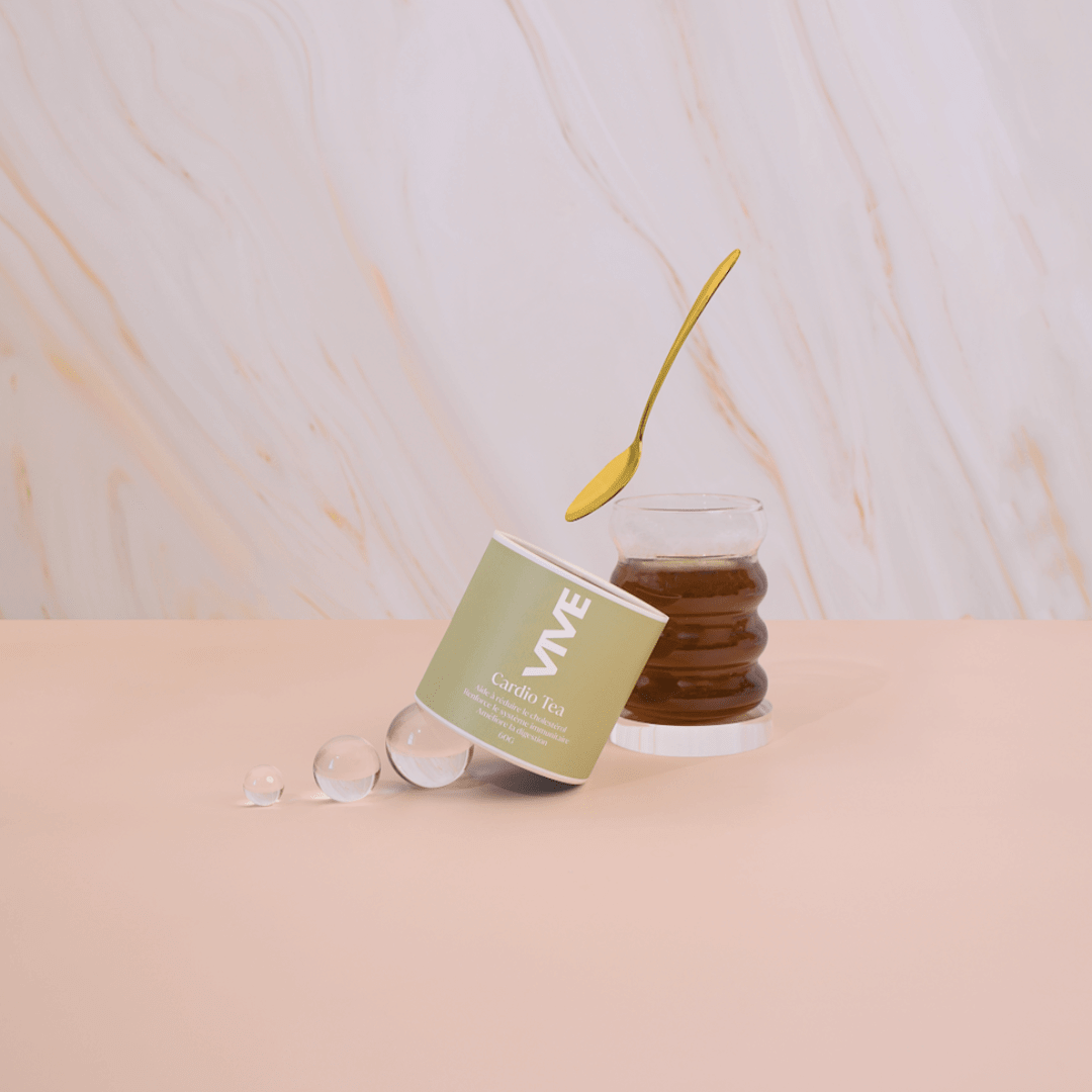 Cardio Tea packaging next to a glass of brewed tea and a golden spoon on a stylish background.