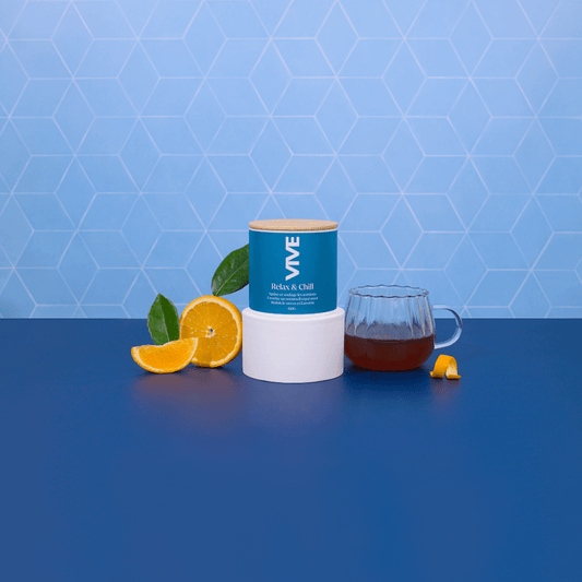 Relax & Chill infusion with orange slices and a glass of tea on a blue background.
